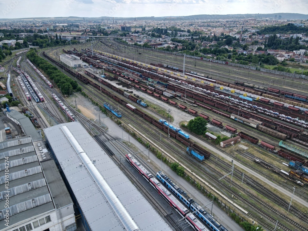 Fototapeta premium Aerial view of a railway marshalling yard. Freight railway cars stand on the tracks. Lots of tracks and railway cars of different colors. Brno, Czech Republic. 