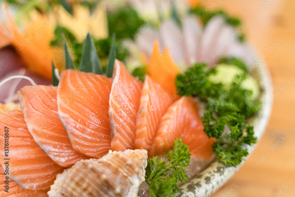 Freshly sliced salmon sashimi arranged on ice in a ceramic bowl, garnished with parsley and seashells for decoration. Freshly sliced salmon sashimi arranged on ice in a ceramic bowl, garnished with parsley and seashells for decoration.