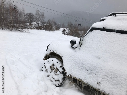 Obraz na płótnie Snow covered off-road vehicle SUV car parked outdoor on a winter ski slope w salonie