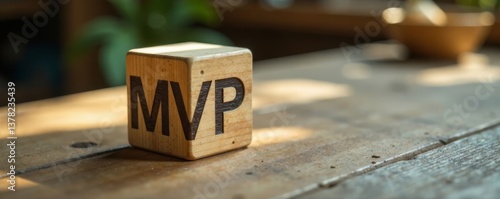 Wooden cube MVP icon on a wooden table with build and measure icons nearby, start up, innovation