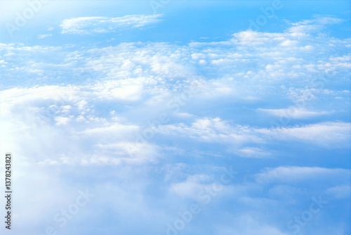 Obraz na płótnie Panoramic view of the atmosphere, with fluffy clouds scattered across the sky. Vast expanse of soft, white clouds, gently drifting across a pale blue sky w salonie