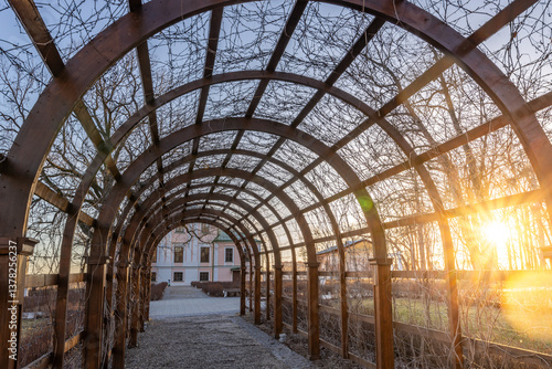 A large archway with a sun shining through it