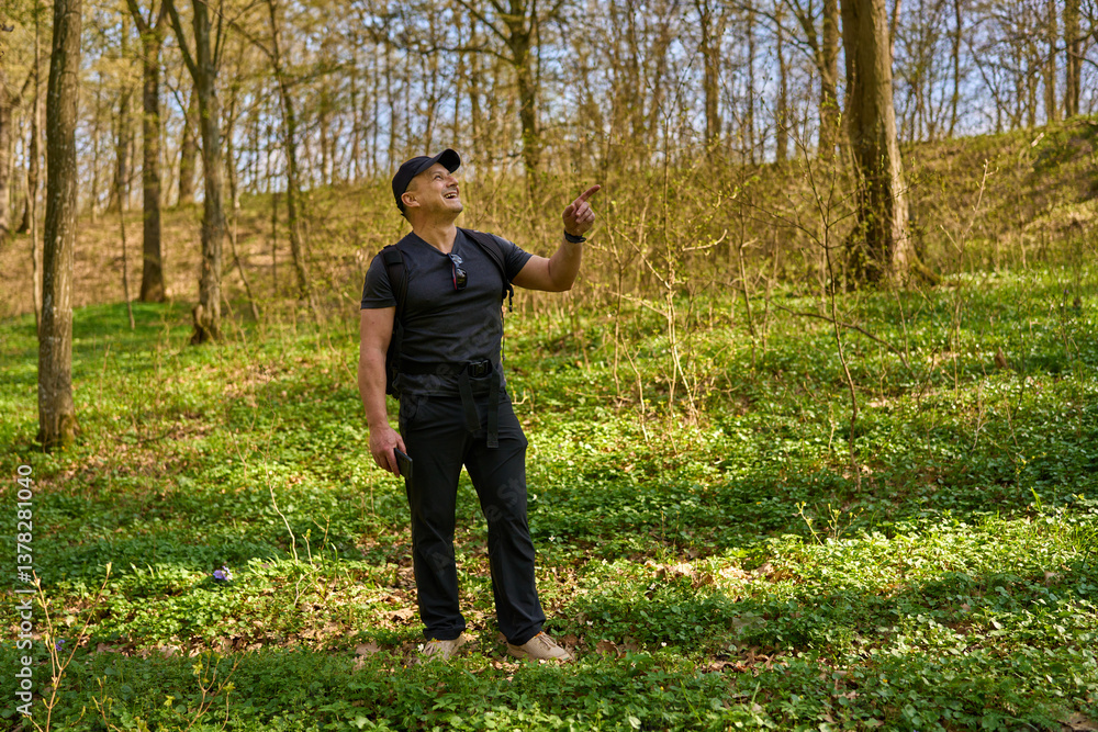 Fototapeta premium Man pointing in spring forest.........