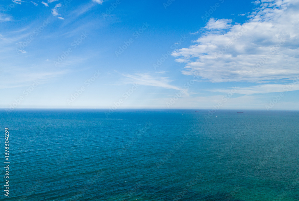 Blue coastal waters under light clouds in sky looking towards the Pacific Ocean Blue coastal waters under light clouds in sky looking towards the Pacific Ocean