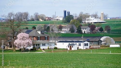 Springtime blooms and vibrant green fields frame the charming homes and farm buildings near Lancaster County, Pennsylvania, U.S