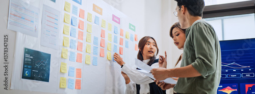 Group of Asian generation z business people work together in home office. Financial team businesspeople brainstorm meeting, use digital tablet and white board presentation. Corporate teamwork concept