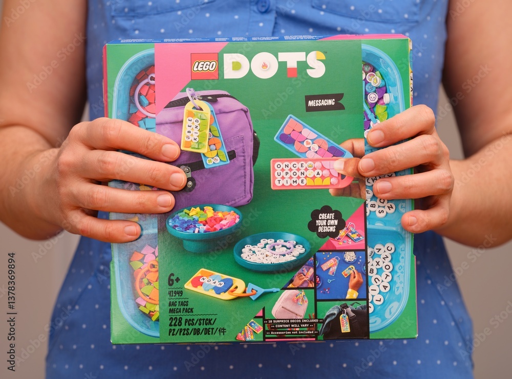 Fototapeta premium Tambov, Russian Federation - December 27, 2023 Woman holding a Lego Dots box