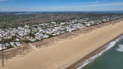 Aerial view of Virginia Beach, VA real estate beach front homes and vacation rentals along the peaceful ocean front coastline with coastal sand dunes