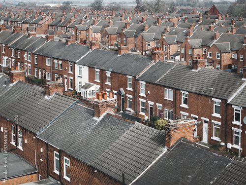 Aerial view above rows of back to back terraced houses on a large council estate