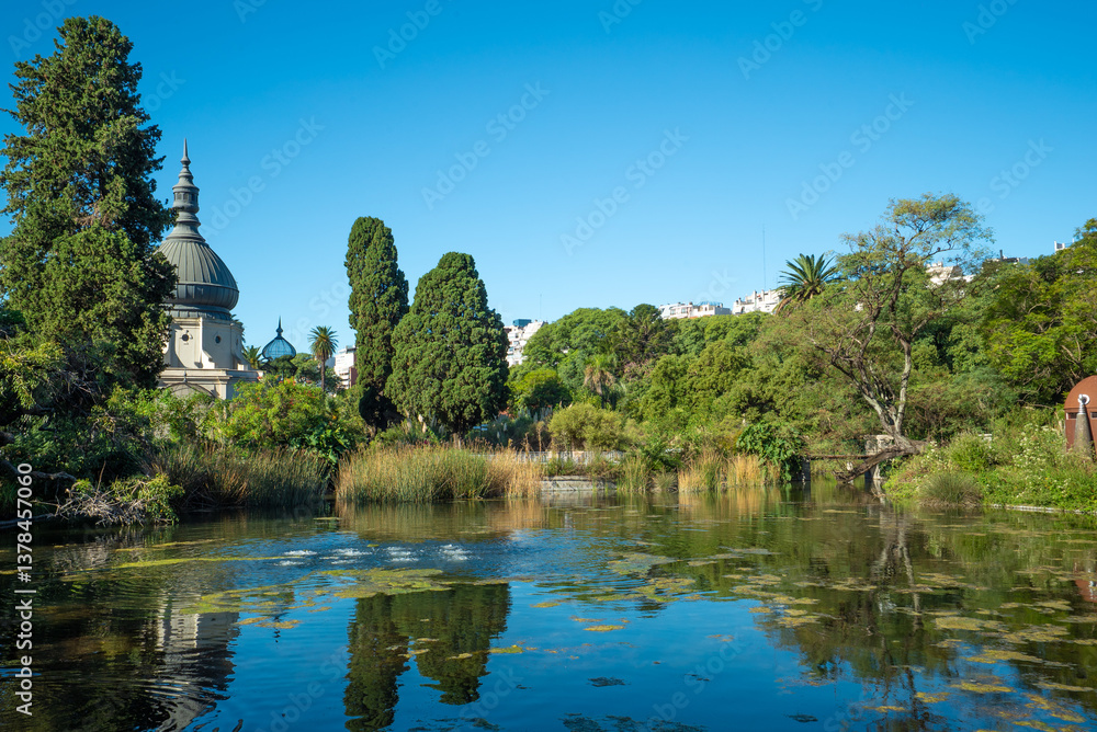 A pond with a building in the background A pond with a building in the background