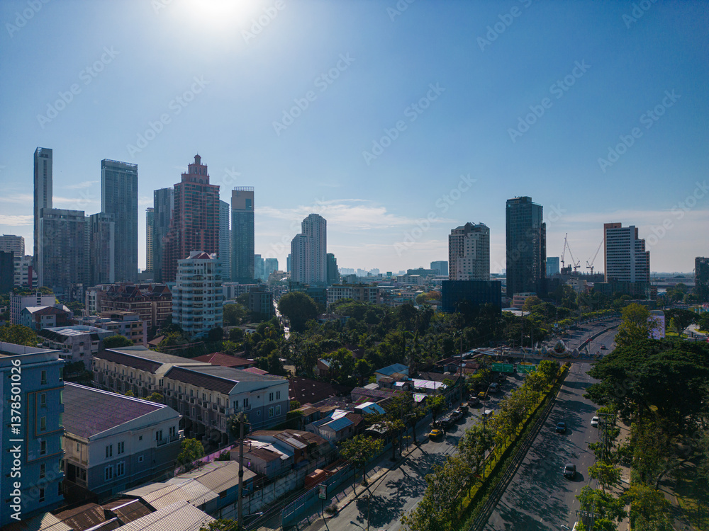 Fototapeta premium Aerial view modern office building with tropical green tree park in Benchakitti public park downtown