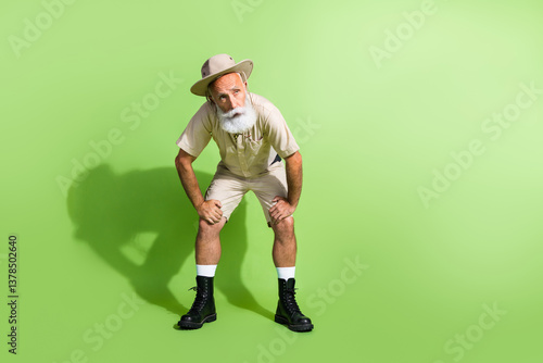 Fotografija Photo of tired adventurer senior man sweating after route trip wear safari suit