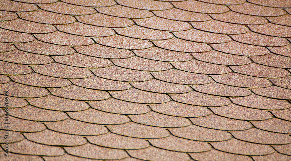 The uniform pattern of overlapping shingles creates a structured, visually appealing surface. The repeating jagged edges add a sense of rhythm and movement to the brown material. The uniform pattern of overlapping shingles creates a structured, visually appealing surface. The repeating jagged edges add a sense of rhythm and movement to the brown material.