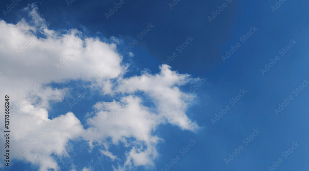 Bright Blue Sky with Fluffy White Clouds in Clear Daytime Atmosphere Bright Blue Sky with Fluffy White Clouds in Clear Daytime Atmosphere