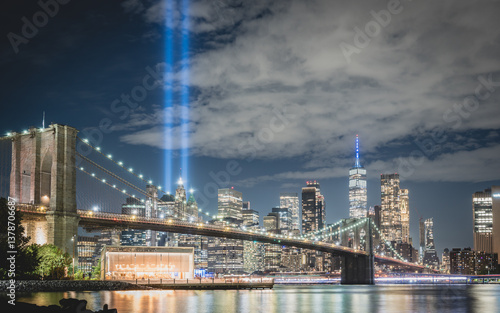 Night view during 9 11 of lower Manhattan and the Brooklyn Bridge with the Tribute in Light in the background