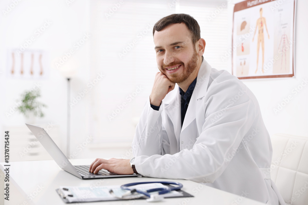 Professional doctor working on laptop at desk in hospital Professional doctor working on laptop at desk in hospital