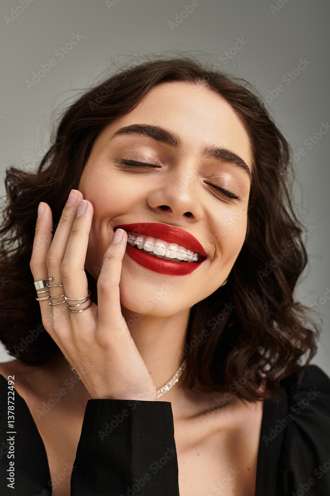 Young woman with striking red lips and charming braces against a neutral backdrop Young woman with striking red lips and charming braces against a neutral backdrop