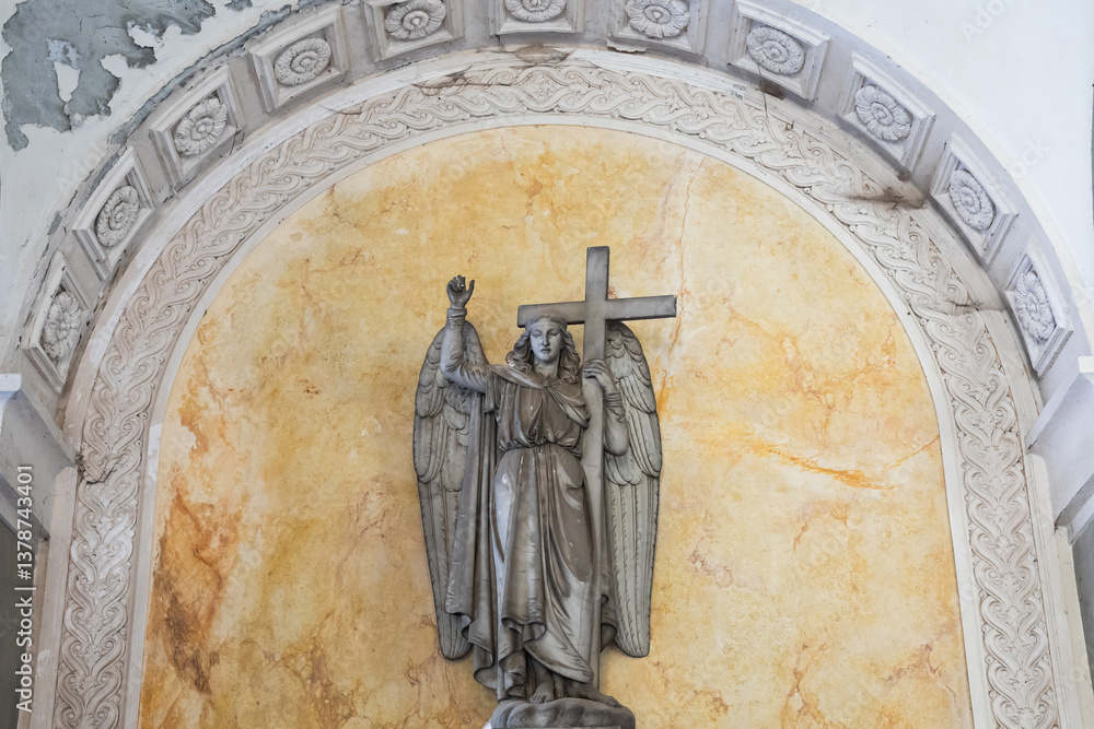 Ancient statue of angel in Italian old cemetery. Religious sculpture, no people, grey marble