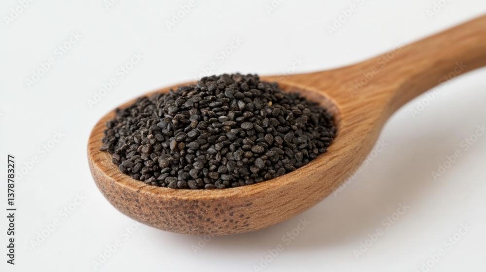 Black seeds in wooden spoon on white background for culinary uses Black seeds in wooden spoon on white background for culinary uses