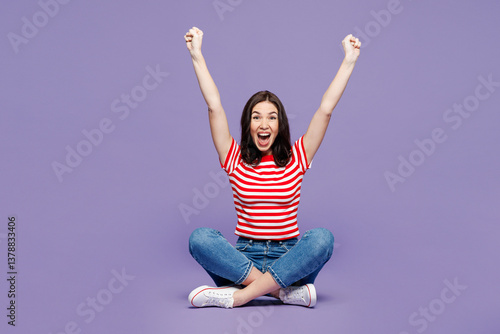 Obraz na płótnie Full body young Caucasian woman she wears red striped t-shirt casual clothes sit do winner gesture looking camera isolated on plain pastel light purple background studio portrait