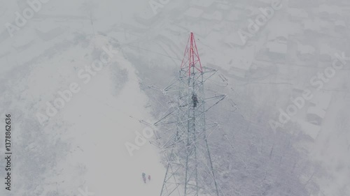  Master works on a high-voltage line in a heavy snowstorm.