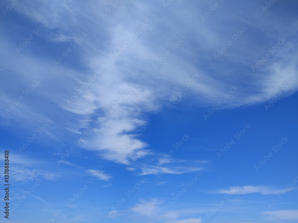 Dramatic Wispy Clouds Against Vibrant Blue Sky Creating Natural Abstract Pattern in Daytime Dramatic Wispy Clouds Against Vibrant Blue Sky Creating Natural Abstract Pattern in Daytime