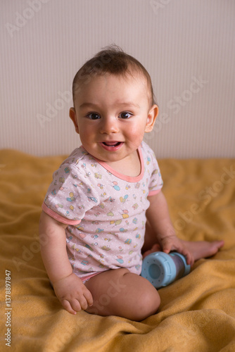 cute baby sitting on the yellow blanket