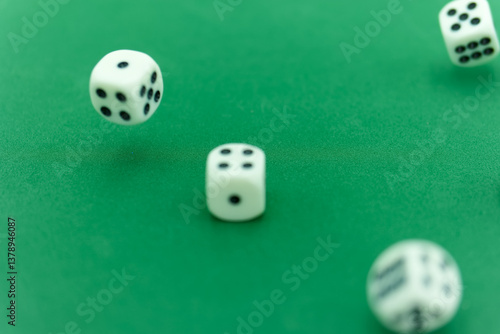 Obraz na płótnie Rolling dice on a green felt surface creates excitement in a gam w salonie
