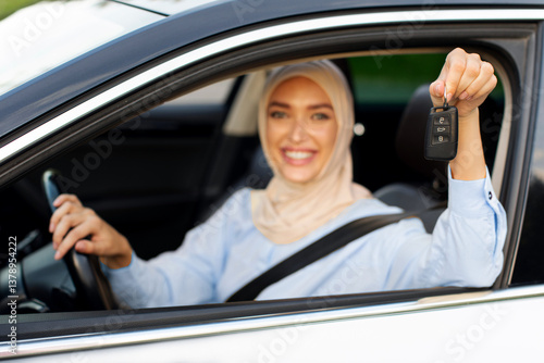 Wallpaper Mural Test drive of new car. Arabian lady showing automobile keys out of window, sitting in vehicle and smiling, selective focus Torontodigital.ca