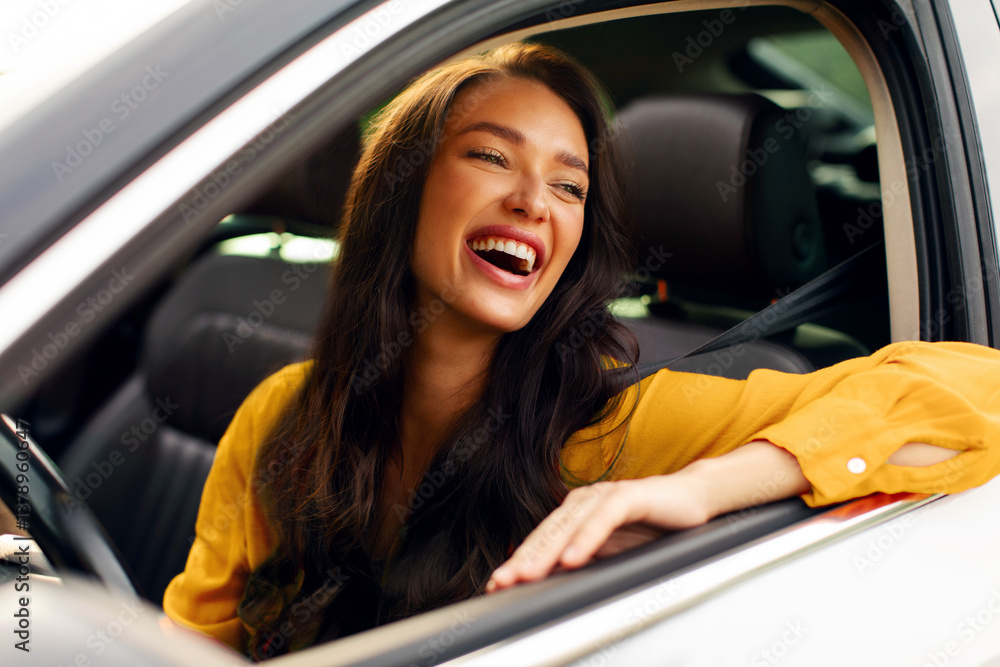 Excited woman sitting in her car, looking out of window and laughing, enjoying trip by automobile Excited woman sitting in her car, looking out of window and laughing, enjoying trip by automobile