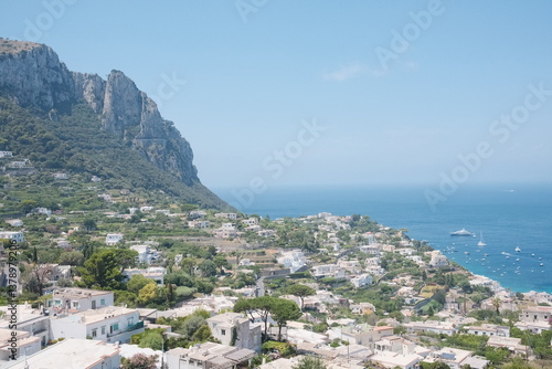 Wallpaper Mural The stunning island of Capri, showcasing a panoramic view of the town, luxurious villas, and yachts sailing on the deep blue waters of the Tyrrhenian Sea under a clear sky. Torontodigital.ca