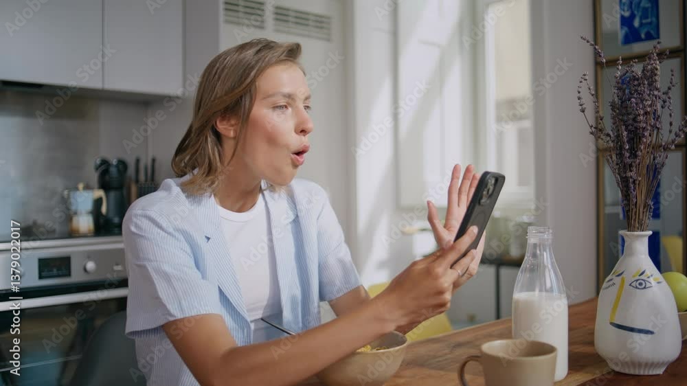Relaxed woman using smartphone at home kitchen. Closeup surprised girl message