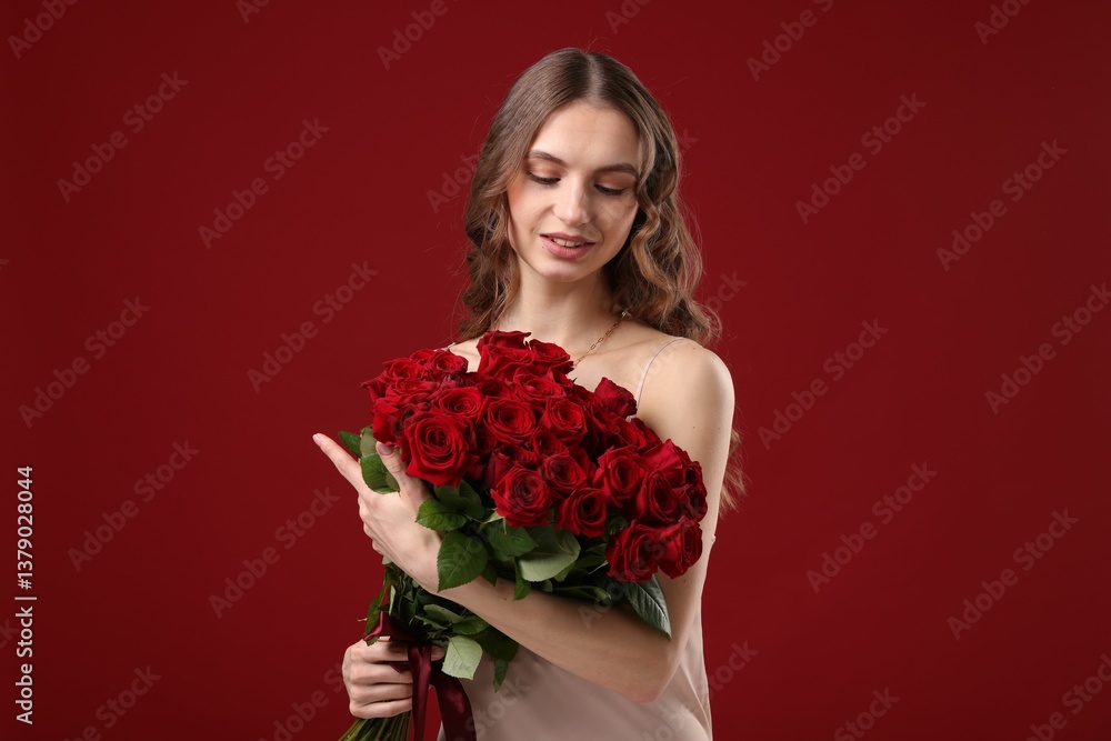 Smiling woman with bouquet of roses on dark red background Smiling woman with bouquet of roses on dark red background