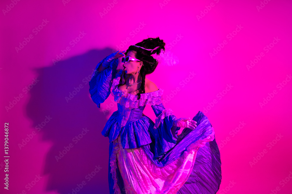 Fototapeta premium Elegant woman in baroque-inspired outfit against vibrant pink neon backdrop highlighting historic and modern blend