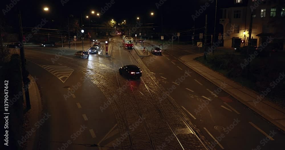 Prague street at night with tram and cars