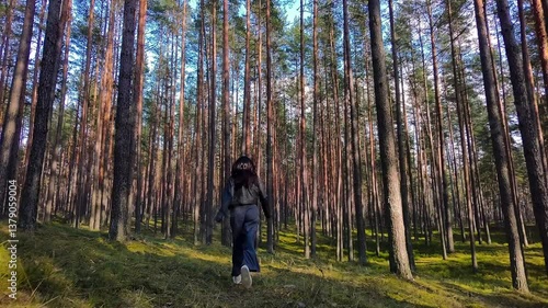 Healthy woman jogging run and workout in forest outdoor.  Latvian runner people exercise gym with fitness session, nature park background. Health and Lifestyle.