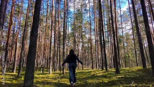 Healthy woman jogging run and workout in forest outdoor.  Latvian runner people exercise gym with fitness session, nature park background. Health and Lifestyle.