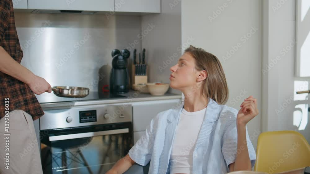 Joyful wife snacking kitchen on weekend closeup. Loving man cooking breakfast Joyful wife snacking kitchen on weekend closeup. Loving man cooking breakfast