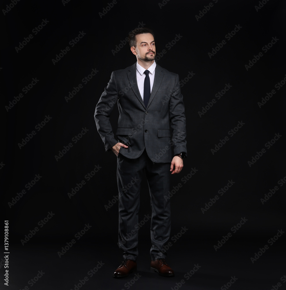 Confident man in classic suit on black background Confident man in classic suit on black background