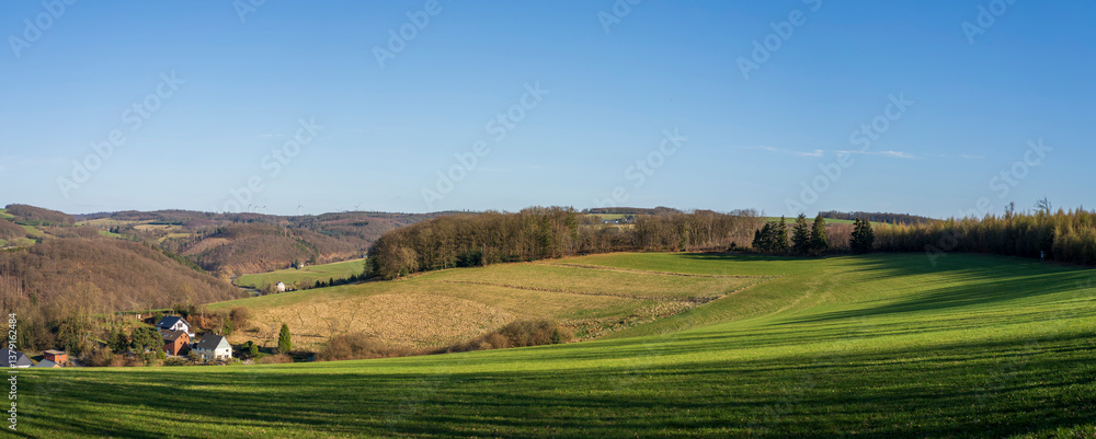 Naklejka premium Panoramic photo of countryside in spring with blue sky and clouds on the horizon. German landscape concept