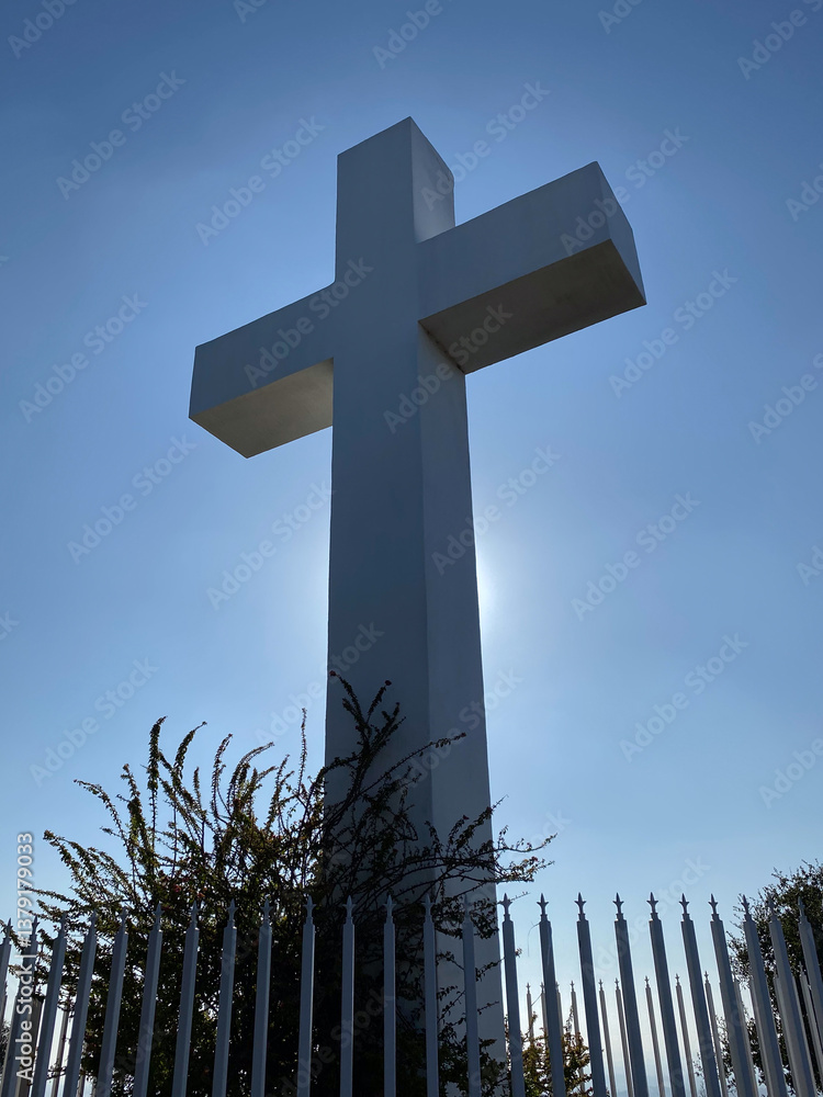 A giant white cross statue representing religious freedom and hope high atop a mountain in San Diego California.