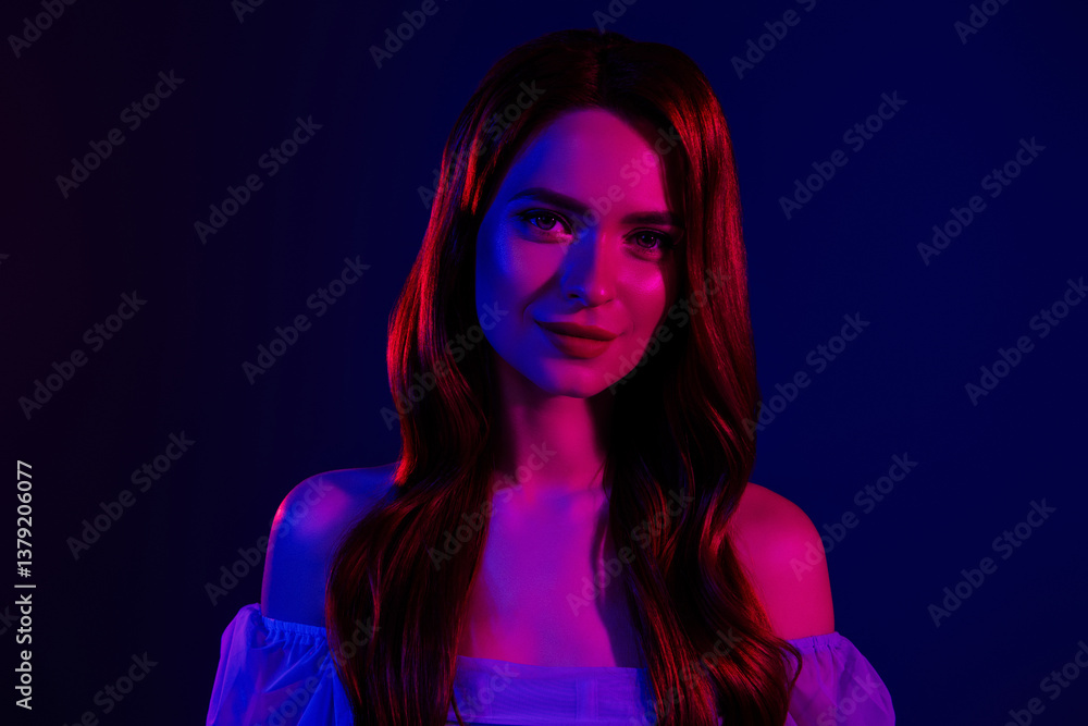 Portrait of a trendy woman with long red hair in dramatic studio lighting with blue and pink hues on dark background Portrait of a trendy woman with long red hair in dramatic studio lighting with blue and pink hues on dark background