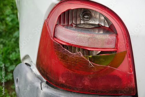 Obraz na płótnie A close-up view shows a damaged car taillight with cracked glass and exposed plastic. w salonie