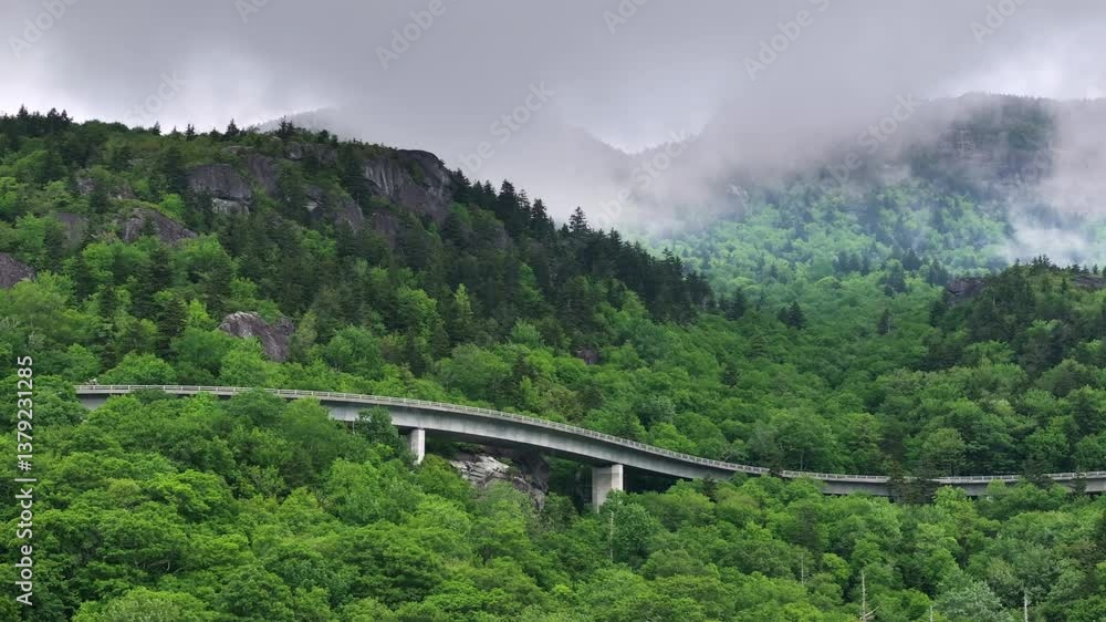 Mountain pass road in North Carolina Appalachian mountains, USA. Linn Cove Viaduct on Blue Ridge Parkway in summer rain season Mountain pass road in North Carolina Appalachian mountains, USA. Linn Cove Viaduct on Blue Ridge Parkway in summer rain season