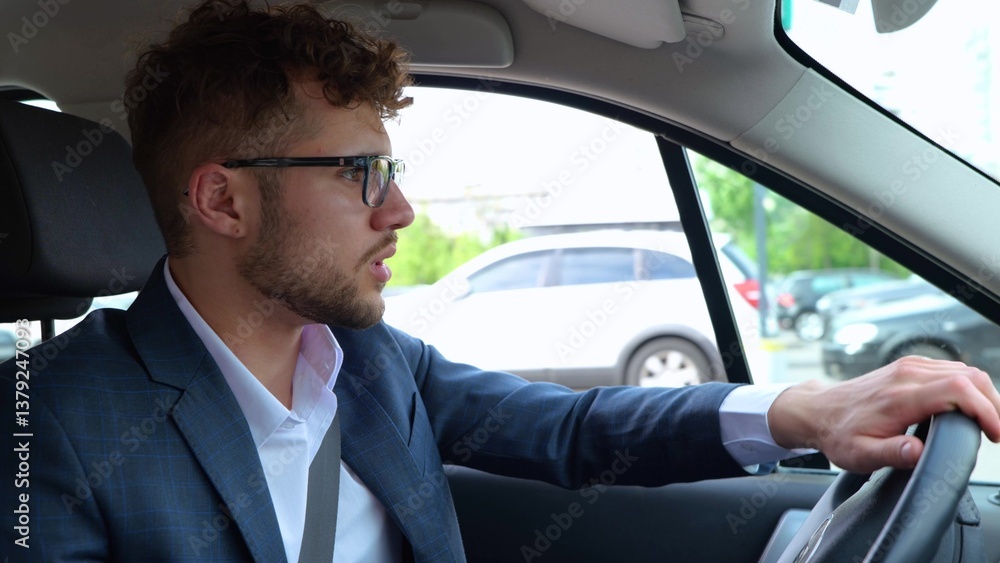 Upset tired young man driving car in the city while stuck in traffic jam. Transport, business, lifestyle and people concept. Slow motion Upset tired young man driving car in the city while stuck in traffic jam. Transport, business, lifestyle and people concept. Slow motion