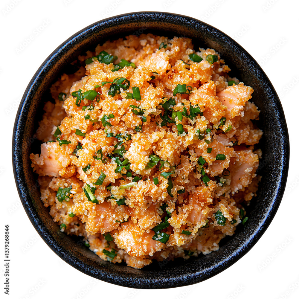 Top-down view of a black ceramic bowl with crispy toasted cassava flour mixed with tender cooked salmon pieces and finely chopped fresh chives Top-down view of a black ceramic bowl with crispy toasted cassava flour mixed with tender cooked salmon pieces and finely chopped fresh chives