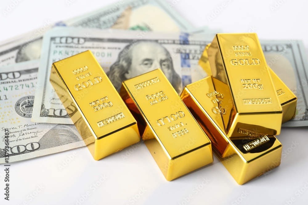 Shiny gold bars and dollar banknotes on white background, closeup Shiny gold bars and dollar banknotes on white background, closeup