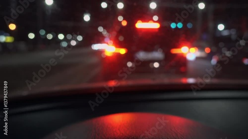 View from a moving car of a car's blinker indicating the direction change at night