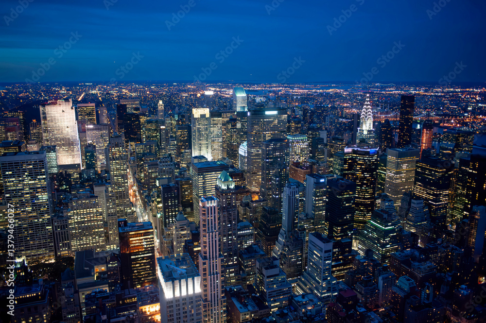 Fototapeta  aerial view of the illuminated new york city skyline at night, featuring the chrysler building
