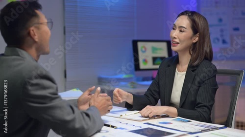 Wallpaper Mural A woman in a business suit is sitting at a desk with a tablet in front of her. She is looking at the tablet and she is focused on the content displayed Torontodigital.ca